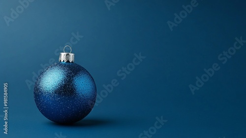 Blue Christmas ornament on dark blue background