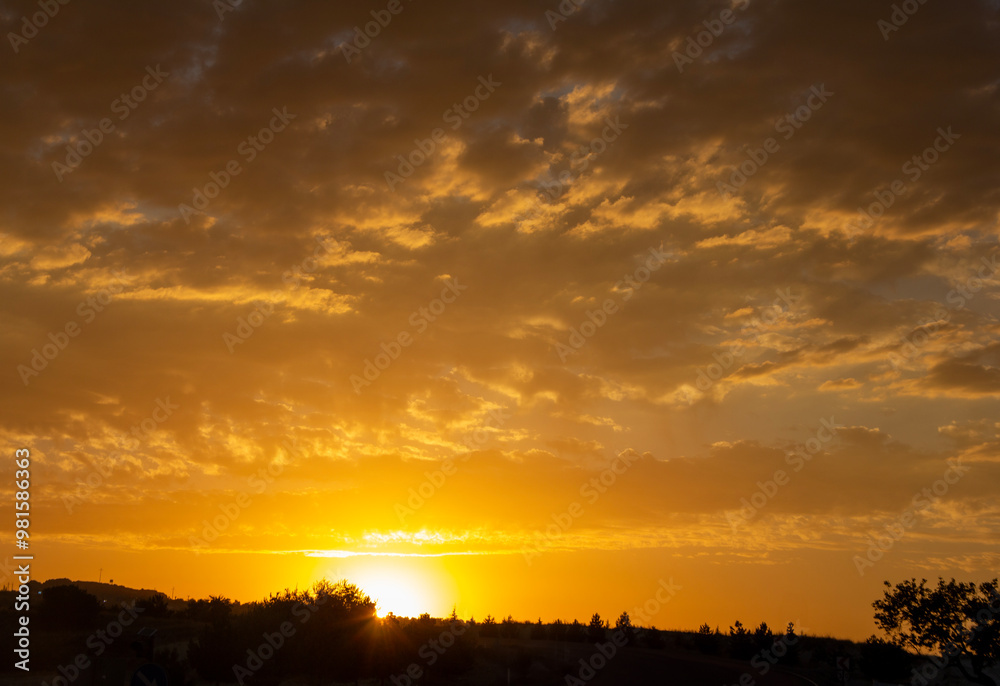 Golden sunset over a tranquil landscape, with warm hues painting the sky and soft clouds illuminated by the setting sun. Golden sunset over a tranquil landscape, with warm hues painting the sky and soft clouds illuminated by the setting sun.