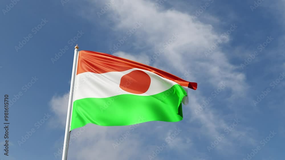 Flag of Niger on a blue sky, flag on a flag pole waving in the wind, african country, national symbol of Niger, video of a flag
Flag of Niger on a blue sky, flag on a flag pole waving in the wind, african country, national symbol of Niger, video of a flag