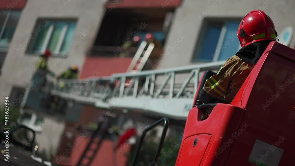 fire truck with extended elevated ladder reaches up to residential building where firefighters in protective gear work on balcony, conducting an emergency response