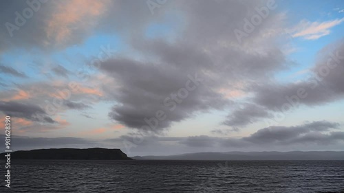 4K Time-Lapse of moving clouds over sea at sunset. The Isle of Skye, Scotland