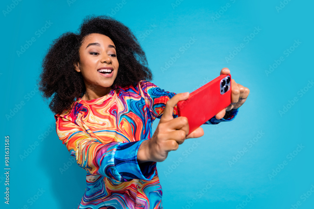 © deagreez - Photo portrait of lovely young lady play excited mobile game dressed stylish colorful garment isolated on blue color background © deagreez - Photo portrait of lovely young lady play excited mobile game dressed stylish colorful garment isolated on blue color background