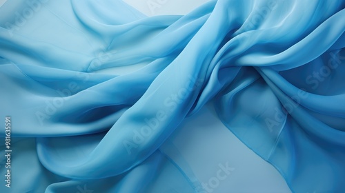 A soft, flowing blue fabric creates a beautiful abstract background.
