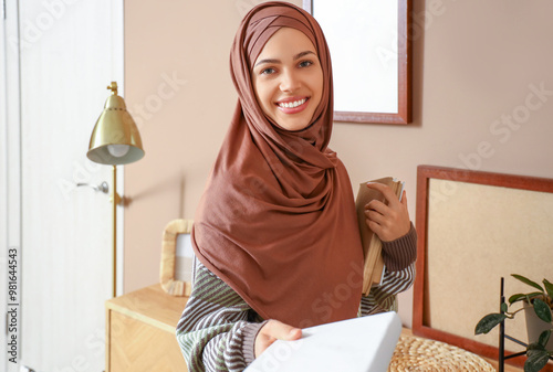 Young Muslim woman with boo...
