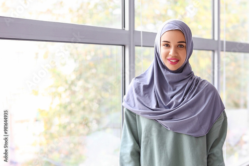 Stylish Muslim woman near w...