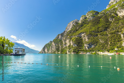 Lake Garda with mountains in background, view from Riva del Garda town shore, Italy, Europe.