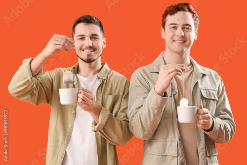 Young men dipping tea bags ...
