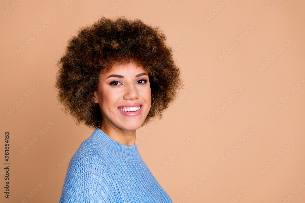 Photo of young funky american lady with brown hair chevelure in knitted sweater smiling after hairdresser isolated on beige color background Photo of young funky american lady with brown hair chevelure in knitted sweater smiling after hairdresser isolated on beige color background