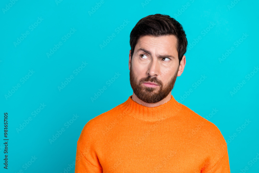 Photo of handsome minded man wear orange trendy clothes look empty space isolated on cyan color background Photo of handsome minded man wear orange trendy clothes look empty space isolated on cyan color background