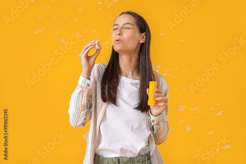 Young woman blowing soap bu...