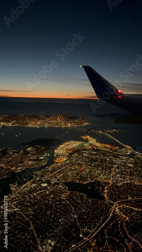 Airplane in the sky over city at night