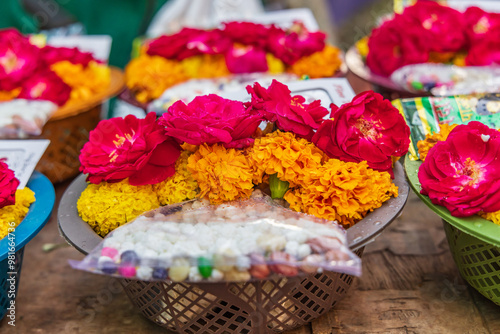 Marigolds and roses for sale at an outdoor market. photo