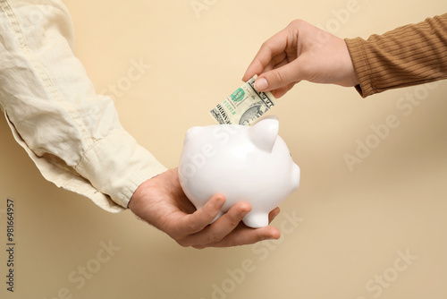 Couple putting money into p...