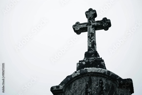 Solitary cross on weathered tombstone under twilight sky