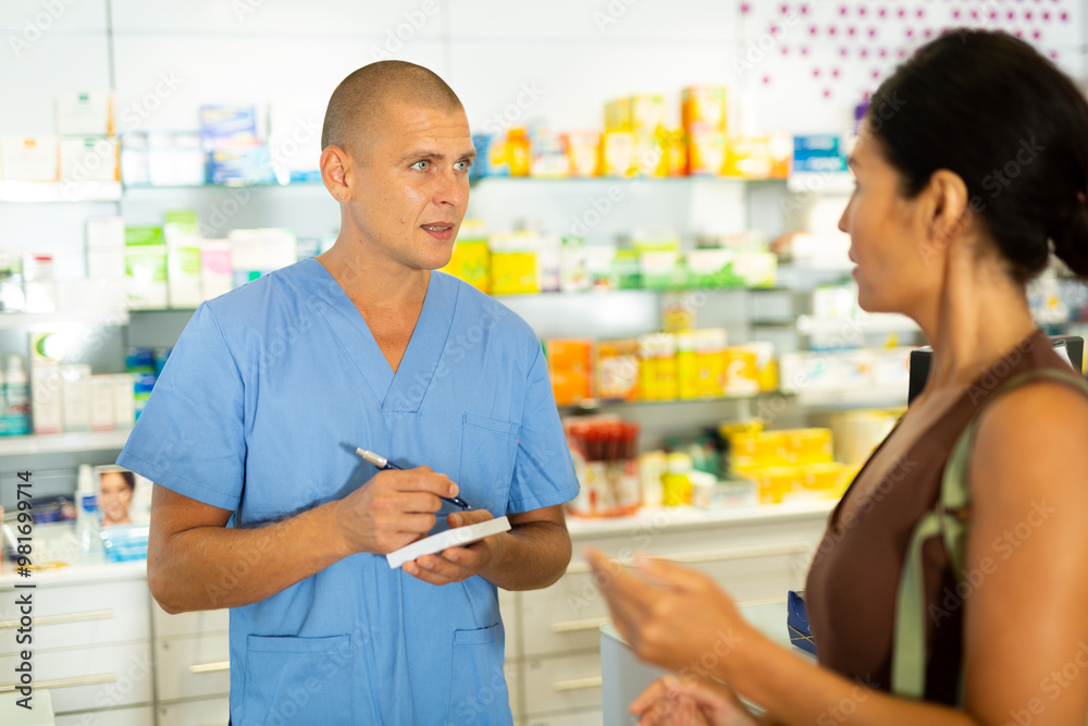 Fototapeta premium Man doctor talking with female client about treatment and writing recipe for her.