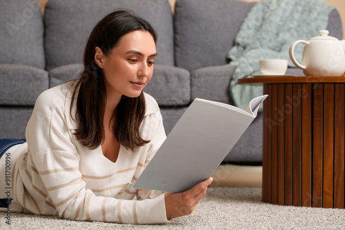 Young woman reading magazin...