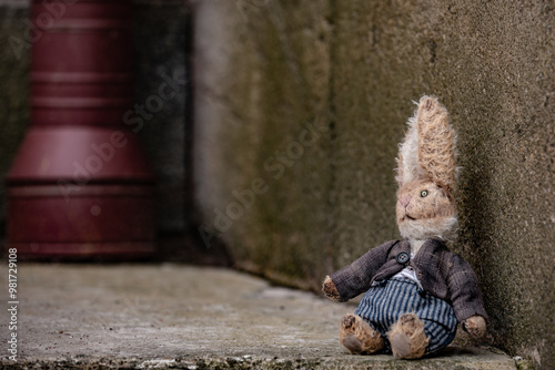 Fototapeta Naklejka Na Ścianę i Meble -  A small handmade toy on the background of a street wall.