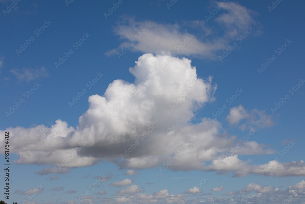Cloudscape photograph of white and grayish fluffy clouds also swirly random clouds covering blue sky. Cloudscape photograph of white and grayish fluffy clouds also swirly random clouds covering blue sky.