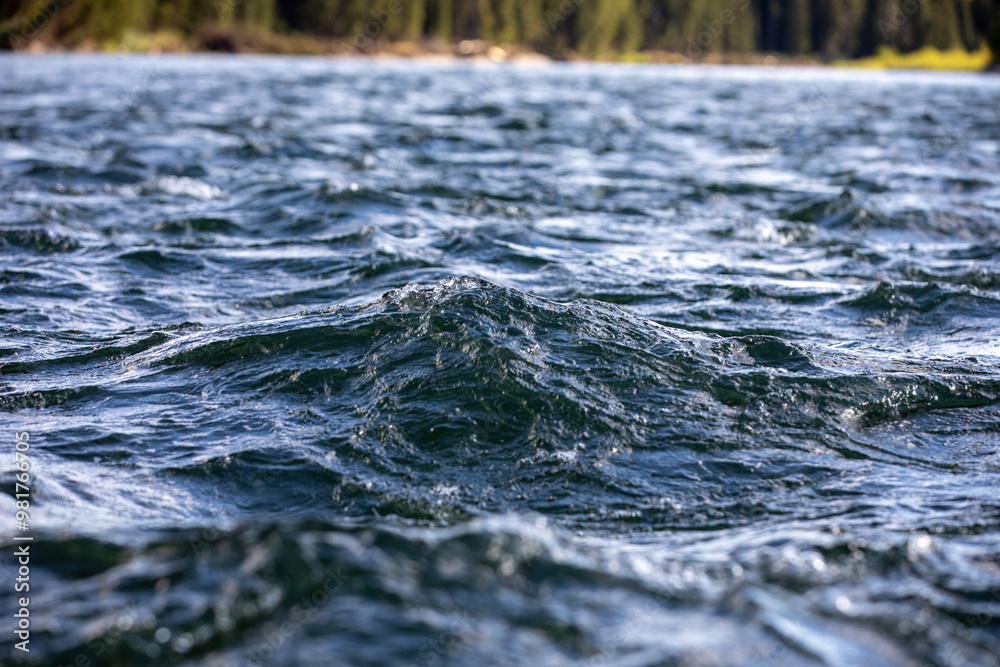Close up photograph of large rippling waves on the surface of Snake River in The Grand Tetons National Park Close up photograph of large rippling waves on the surface of Snake River in The Grand Tetons National Park