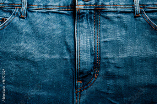 Close-up of denim jeans displaying intricate stitching and fabric quality for fashion-related use. photo