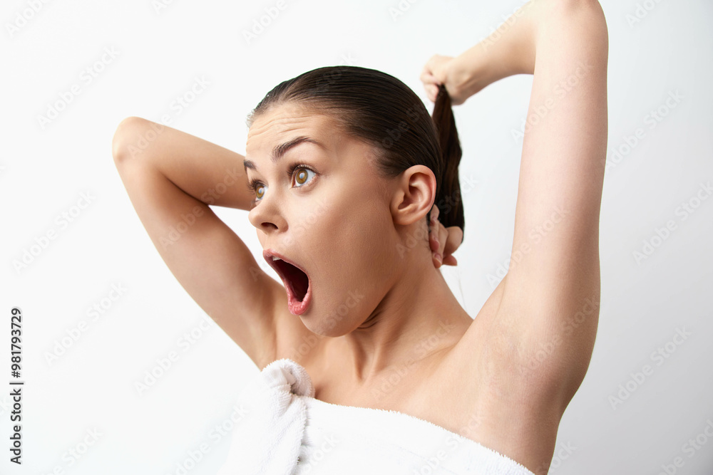 surprised young woman with an open mouth and raised hands, holding her hair, on a white background, expressing shock or disbelief in a clean, minimalist setting surprised young woman with an open mouth and raised hands, holding her hair, on a white background, expressing shock or disbelief in a clean, minimalist setting