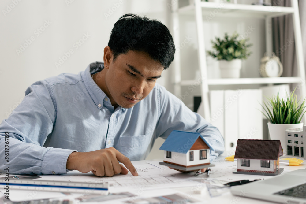 Architect working drawing draft on blueprints in the office, working with modern house blueprint floorplans, architectural and construction project concept. Architect working drawing draft on blueprints in the office, working with modern house blueprint floorplans, architectural and construction project concept.