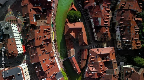 Forward moving, top down view drone shot. Bright and cloudy day , Partially cloudy Partially sunny day in Annecy France  following Thiou river into the city.