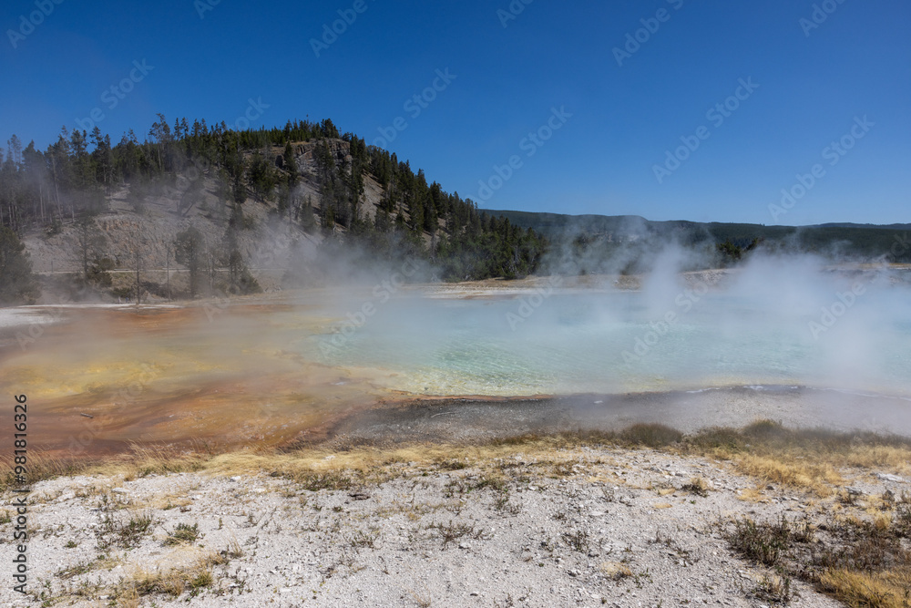 Hot steam rising from hot spring, geothermal feature at Yellowstone National Park in Wyoming Hot steam rising from hot spring, geothermal feature at Yellowstone National Park in Wyoming