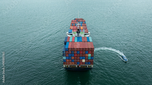 Aerial rear view Container Ship load container going to seaport or unload at container warehouse on the green sea. Logistics, import export, shipping or transportation Asia Pacific photo