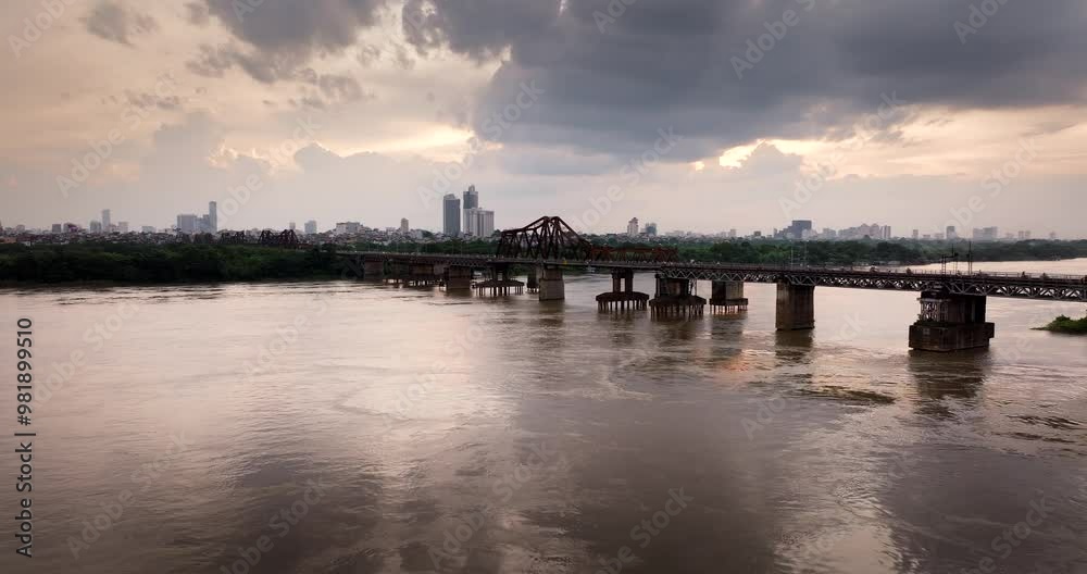 Long Bien bridge across the Red River with Hanoi skyline in background at beautiful sunset, Riverbed erosion and degradation in Red river, Aerial Long Bien bridge across the Red River with Hanoi skyline in background at beautiful sunset, Riverbed erosion and degradation in Red river, Aerial