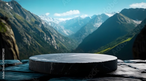 A circular stone platform sits on a ledge overlooking a vast mountain landscape under a clear blue sky, podium. photo