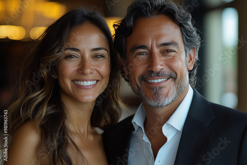 Smiling couple portrait, woman with long brown hair, man with graying hair.