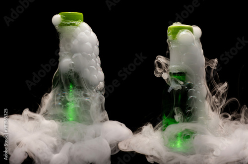 Smoke filled and bubble filled plastic bottles with bubbles and foam busting out photo