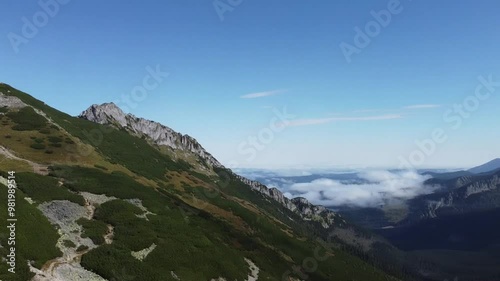 Panning right from Giewont to clouds Tatry mountains, Poland, summertime, aerial view from drone