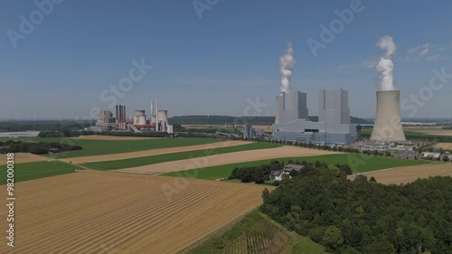 Two Big Cooling Towers Of Active Block Unit Of Neurath Power Station In Grevenbroich, Germany. Aerial Pullback Shot photo