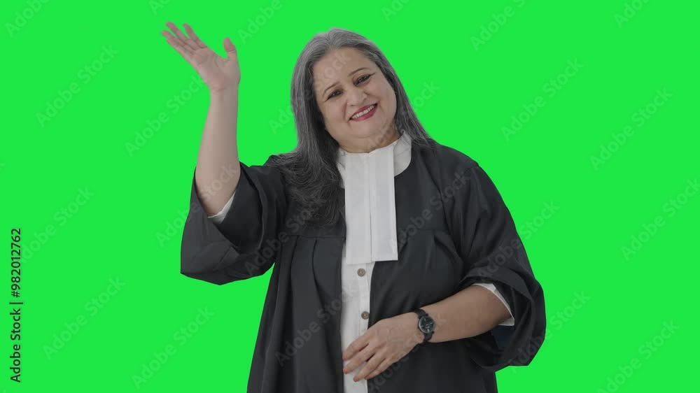 Happy Indian senior female lawyer saying Hello and waving Green screen Happy Indian senior female lawyer saying Hello and waving Green screen