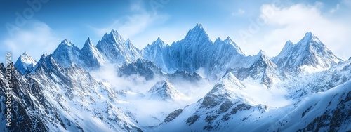 Beautiful snow-covered mountains against the blue sky. Panoramic view of a winter landscape in the highlands