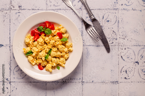 Sacсhettini pasta in a plate with tomato sauce. photo