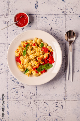 Sacсhettini pasta in a plate with tomato sauce. photo