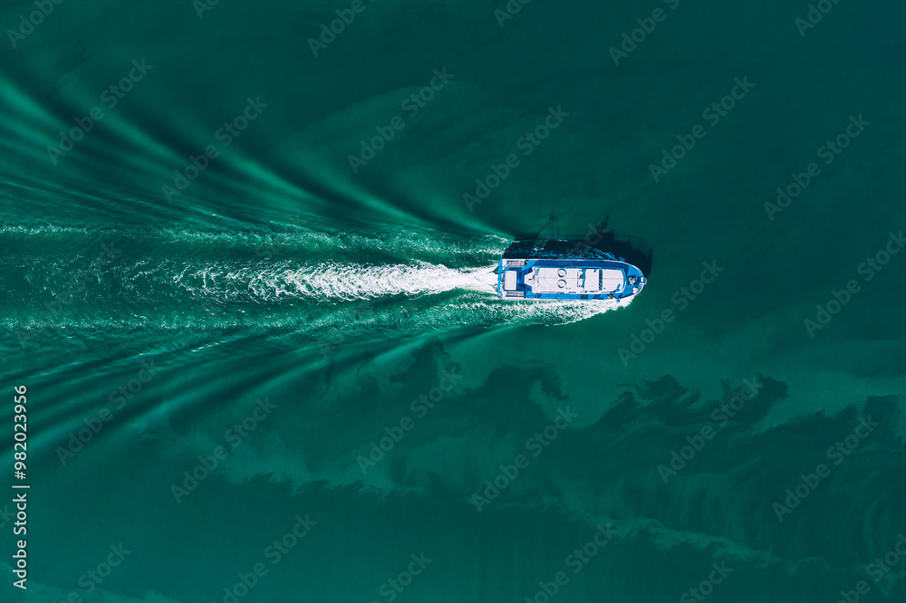 Aerial drone view of shipping offshore vessel or barge in turquoise blue water river sea ocean. Amazing summer landscape Aerial drone view of shipping offshore vessel or barge in turquoise blue water river sea ocean. Amazing summer landscape