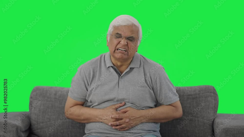 Sick Indian old man suffering from stomach pain Green screen Sick Indian old man suffering from stomach pain Green screen