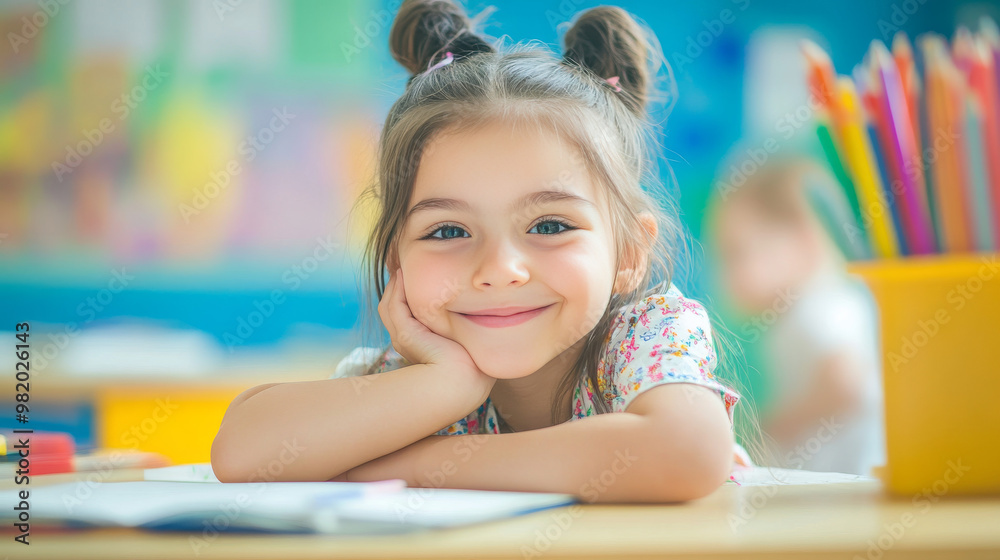 A charming illustration of a young girl in a classroom, focused on her exam while drawing in her notebook. Her smile radiates joy as she engages in creative art, surrounded by colorful books . A charming illustration of a young girl in a classroom, focused on her exam while drawing in her notebook. Her smile radiates joy as she engages in creative art, surrounded by colorful books .
