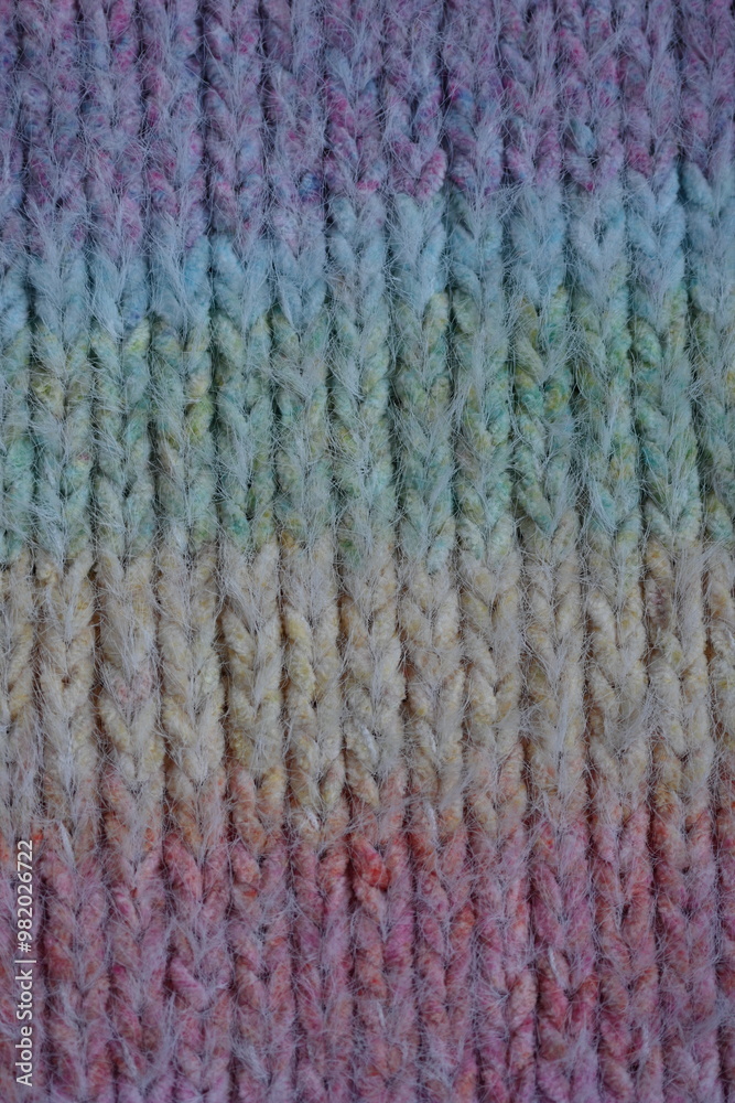 Macro texture of acrylic multicolored rainbow pastel crocheted winter clothing sweater as background, close-up of rainbow front surface, multicolored wool texture, crocheted front surface, part of sca Macro texture of acrylic multicolored rainbow pastel crocheted winter clothing sweater as background, close-up of rainbow front surface, multicolored wool texture, crocheted front surface, part of sca