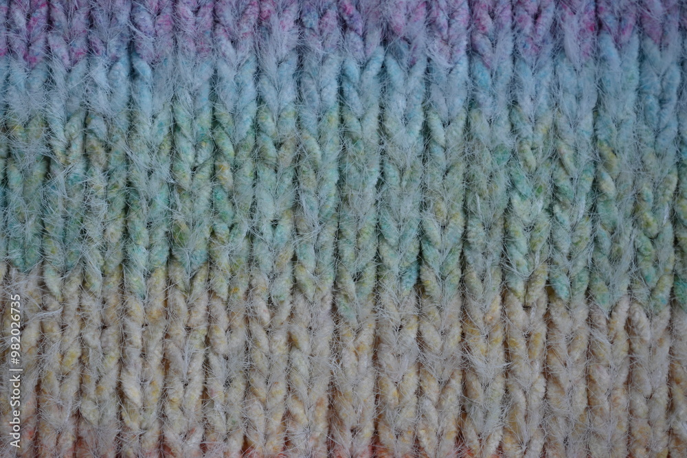 Macro texture of acrylic multicolored rainbow pastel crocheted winter clothing sweater as background, close-up of rainbow front surface, multicolored wool texture, crocheted front surface, part of sca Macro texture of acrylic multicolored rainbow pastel crocheted winter clothing sweater as background, close-up of rainbow front surface, multicolored wool texture, crocheted front surface, part of sca