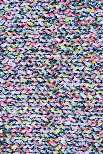 Macro texture of acrylic multicolored rainbow pastel crocheted winter clothing sweater as background, close-up of rainbow front surface, multicolored wool texture, crocheted front surface, part of sca