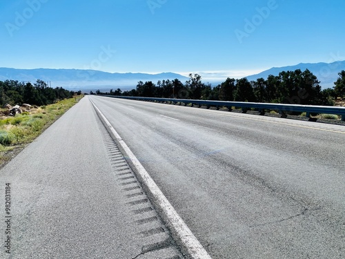Empty Desert Highway with Mountain View on a Clear Day

