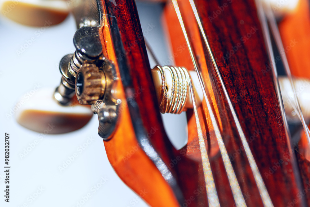 Classical guitar tuner buttons and nylon strings. Acoustic guitar strings, details and craftsmanship