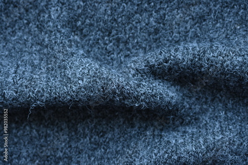  close-up of gray crocheted front surface, woolen texture of woolen wool, knitted front surface, macro texture of woolen dark gray crocheted sweater as background photo