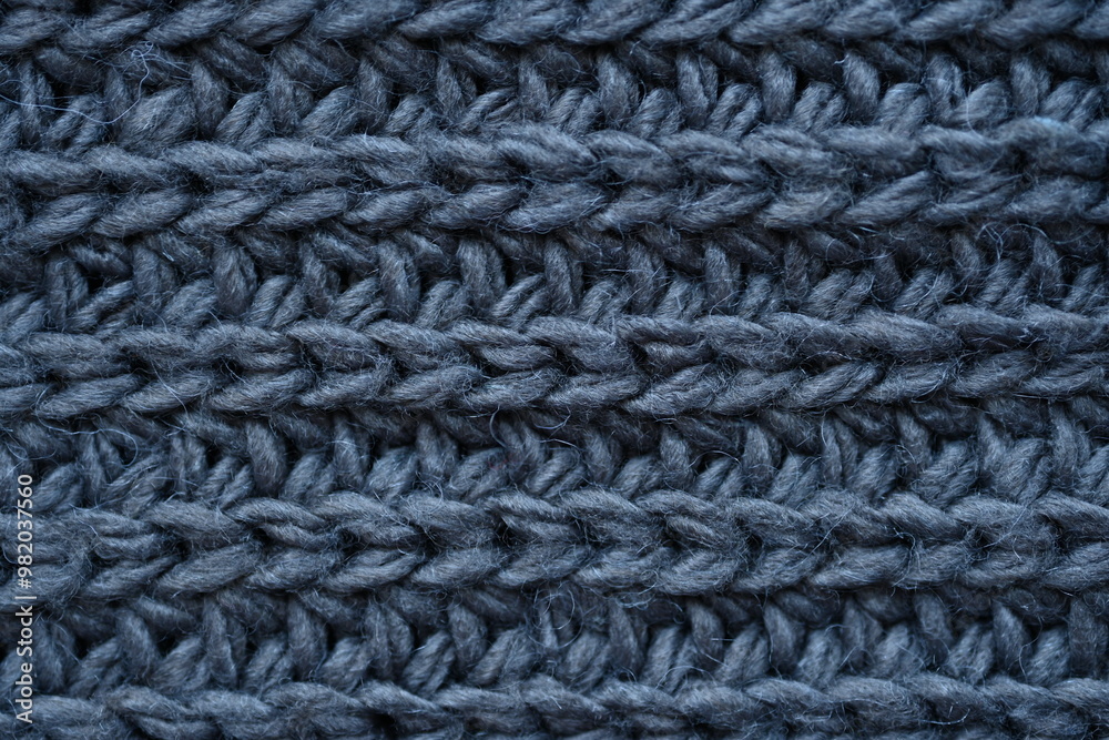macro texture of woolen dark gray crocheted sweater as background, close-up of gray crocheted front surface, woolen texture of woolen wool, knitted front surface macro texture of woolen dark gray crocheted sweater as background, close-up of gray crocheted front surface, woolen texture of woolen wool, knitted front surface