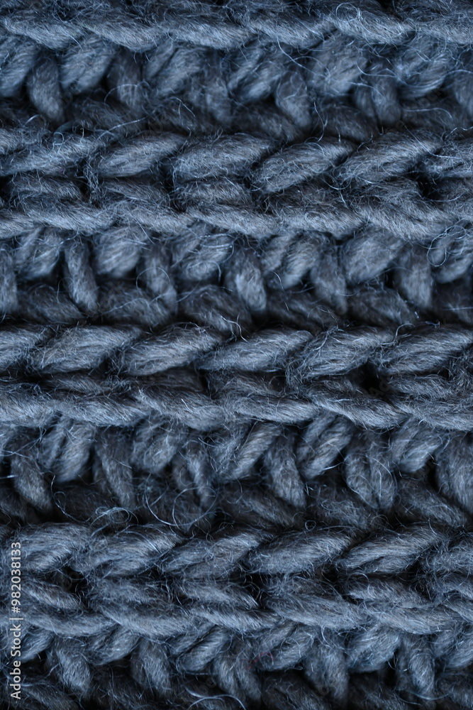 macro texture of woolen dark gray crocheted sweater as background, close-up of gray crocheted front surface, woolen texture of woolen wool, knitted front surface macro texture of woolen dark gray crocheted sweater as background, close-up of gray crocheted front surface, woolen texture of woolen wool, knitted front surface